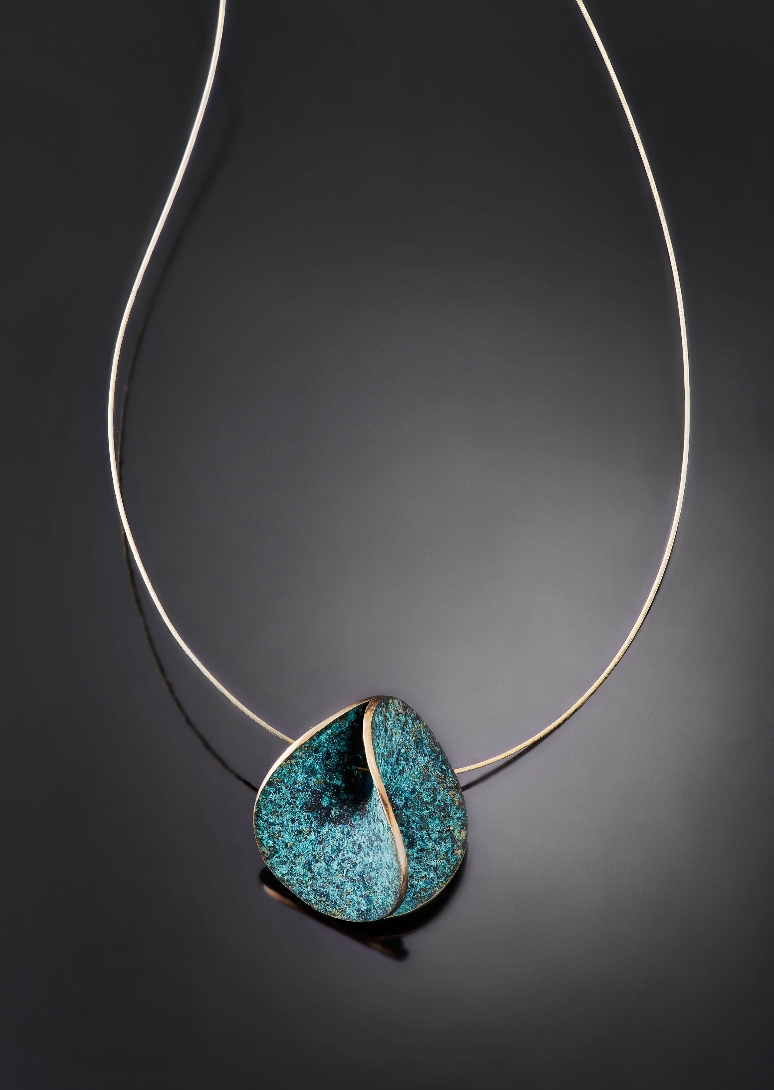 cast-bronze-enneper-pendant-with-classic-blue-green-patina-on-black